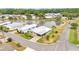 High angle view of a residential neighborhood near a tranquil lake, surrounded by green trees and well kept landscaping at 2101 Cypress Cross Dr, Lakeland, FL 33810
