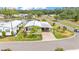 Scenic aerial view of home with lush landscaping, covered carport, and peaceful pond nearby at 2101 Cypress Cross Dr, Lakeland, FL 33810