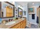 Bathroom featuring a double vanity, framed mirrors, and decorative accents at 2101 Cypress Cross Dr, Lakeland, FL 33810