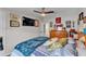 Comfortable bedroom with mounted TV, ceiling fan, and view into the ensuite bathroom at 2101 Cypress Cross Dr, Lakeland, FL 33810