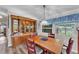 Formal dining room with a wooden table, hutch, and bright window with a blue valance at 2101 Cypress Cross Dr, Lakeland, FL 33810