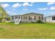 Charming home with green exterior, red shutters, well-maintained lawn, and inviting curb appeal at 2101 Cypress Cross Dr, Lakeland, FL 33810