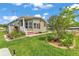 Single-story home with lush green lawn and garden bed near the front entrance at 2101 Cypress Cross Dr, Lakeland, FL 33810