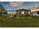 Inviting home with well-maintained lawn, enclosed porch, and fresh exterior paint for a modern look at 2101 Cypress Cross Dr, Lakeland, FL 33810