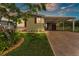 Charming home featuring a covered carport, beautifully landscaped front yard, and a freshly painted exterior at 2101 Cypress Cross Dr, Lakeland, FL 33810