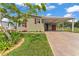 Charming home featuring a covered carport, beautifully landscaped front yard, and a freshly painted exterior at 2101 Cypress Cross Dr, Lakeland, FL 33810