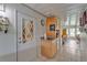Hallway with tile flooring, utility sink, cabinets, and view of a sunroom at 2101 Cypress Cross Dr, Lakeland, FL 33810