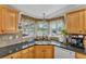 Close up on kitchen sink featuring updated fixtures, granite counters and bright natural light at 2101 Cypress Cross Dr, Lakeland, FL 33810