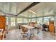 Bright sunroom with many windows, vinyl flooring, seating, and workspace at 2101 Cypress Cross Dr, Lakeland, FL 33810