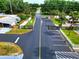 Neighborhood entry with a security gate, tropical trees, and manicured lawns at 211 Sweet Cir, Winter Haven, FL 33884
