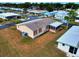 Aerial view of a quaint home with a screened-in patio in a well-planned community at 211 Sweet Cir, Winter Haven, FL 33884
