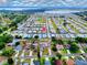 An aerial view shows this lovely home nestled in a charming neighborhood near a beautiful lake at 211 Sweet Cir, Winter Haven, FL 33884