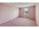 Cozy bedroom with pink walls and carpet, featuring a window with natural light at 211 Sweet Cir, Winter Haven, FL 33884