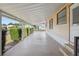 Spacious covered carport with a concrete floor and steps leading to the front door at 211 Sweet Cir, Winter Haven, FL 33884