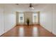 Bright living room featuring wood floors, neutral walls, and abundant natural light from the two windows at 211 Sweet Cir, Winter Haven, FL 33884
