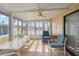 Enclosed sun room featuring tile floor, ceiling fan and large windows at 211 Sweet Cir, Winter Haven, FL 33884