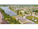Picturesque aerial shot of a community featuring a pond, sand volleyball court and residential homes at 2112 Betsy Ross Ln, St Cloud, FL 34769