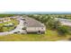 Aerial shot showing a row of townhomes next to a highway and bordered by a line of trees at 2112 Betsy Ross Ln, St Cloud, FL 34769