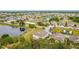 Beautiful aerial view of a community with a pond, sand volleyball court, and lush landscaping at 2112 Betsy Ross Ln, St Cloud, FL 34769