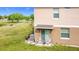 Inviting backyard patio with chairs, sliding glass door, and views of a lush green space at 2112 Betsy Ross Ln, St Cloud, FL 34769