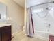 Bright bathroom with a shower-tub combo, neutral-colored tile, and a modern vanity for functionality at 2112 Betsy Ross Ln, St Cloud, FL 34769