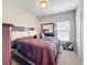 Cozy bedroom showcasing a comfortable bed with a maroon comforter, dresser, and ample natural light at 2112 Betsy Ross Ln, St Cloud, FL 34769