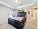 Well-lit bedroom featuring a comfortable bed with dark furniture, carpet, and ample natural light at 2112 Betsy Ross Ln, St Cloud, FL 34769