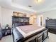 Inviting bedroom with a black wooden bed frame, carpet, a side table, and bright natural light at 2112 Betsy Ross Ln, St Cloud, FL 34769