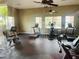 Well-equipped gym featuring treadmills, elliptical, and bike machines and multiple ceiling fans at 2112 Betsy Ross Ln, St Cloud, FL 34769