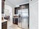 Kitchen featuring stainless steel refrigerator, dark cabinets, and tiled floors at 2112 Betsy Ross Ln, St Cloud, FL 34769