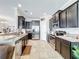 Spacious kitchen with stainless steel appliances, dark cabinets, granite counters, and tile floors at 2112 Betsy Ross Ln, St Cloud, FL 34769