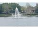 Community featuring a serene lake with a fountain and recreational facilities along the shoreline at 2112 Betsy Ross Ln, St Cloud, FL 34769