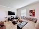 Cozy living room featuring a sectional couch, large TV, and tile floors at 2112 Betsy Ross Ln, St Cloud, FL 34769