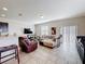Comfortable living room featuring a large sectional couch, TV, and tile floors at 2112 Betsy Ross Ln, St Cloud, FL 34769