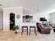 Open living space featuring bar top, adjacent to kitchen and sitting area at 2112 Betsy Ross Ln, St Cloud, FL 34769