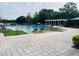 Resort-style pool area featuring lounge chairs, a pergola, and meticulously maintained deck at 2112 Betsy Ross Ln, St Cloud, FL 34769