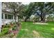 Landscaped backyard featuring a fire pit, lush lawn, and garden at 2115 W Pipkin Rd, Lakeland, FL 33811