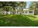 Manicured backyard with expansive lawn and exterior view of the property at 2115 W Pipkin Rd, Lakeland, FL 33811