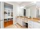 Elegant bathroom with a double vanity, granite countertops, and a view of a nearby mudroom at 2115 W Pipkin Rd, Lakeland, FL 33811