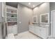 Bright bathroom features double sinks, a marble countertop, and a built-in linen closet at 2115 W Pipkin Rd, Lakeland, FL 33811