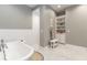 Elegant bathroom features tub, walk-in shower, and built-in storage cabinets at 2115 W Pipkin Rd, Lakeland, FL 33811