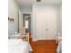 Light blue bedroom featuring hardwood floors, twin beds with floral bedding, and double doors to the closet at 2115 W Pipkin Rd, Lakeland, FL 33811