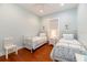 Charming bedroom with light blue walls, hardwood floors, and two twin beds with floral bedding at 2115 W Pipkin Rd, Lakeland, FL 33811
