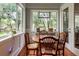 Charming breakfast nook with sunlit windows offers serene views and a perfect spot for casual dining at 2115 W Pipkin Rd, Lakeland, FL 33811