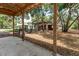 Detached carport next to a building with garage doors and a fenced yard at 2115 W Pipkin Rd, Lakeland, FL 33811