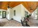 Expansive covered porch with ceiling fans, rocking chairs, and brick flooring at 2115 W Pipkin Rd, Lakeland, FL 33811