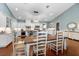 Dining area with a large table, chairs, and adjacent kitchen featuring white cabinetry and modern appliances at 2115 W Pipkin Rd, Lakeland, FL 33811