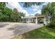 Sprawling single-story home with a metal roof, covered parking, and brick driveway at 2115 W Pipkin Rd, Lakeland, FL 33811