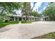 Charming single-story home with a metal roof, wraparound porch, and brick driveway at 2115 W Pipkin Rd, Lakeland, FL 33811