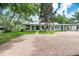 Charming single-story home with a metal roof, wraparound porch, and brick driveway at 2115 W Pipkin Rd, Lakeland, FL 33811